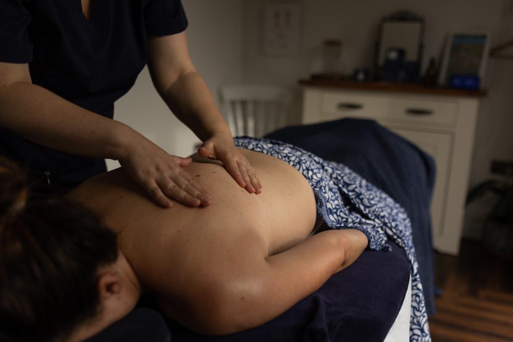 A person providing a back massage